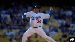 FILE - Fernando Valenzuela throws to the plate during the Old-Timers baseball game, in Los Angeles, June 8, 2013.