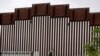 Petugas pengamanan perbatasan berjalan di sepanjang tembok perbatasan antara Tijuana, di Meksiko, dan San Diego di Amerika Serikat, 18 Maret 2020. (Foto: AP Photo/Gregory Bull)