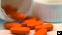 FILE - Pills of ibuprofen are seen in New York, Nov. 2, 2017. A derivative of the common painkiller is being tested for treatment of coronavirus respiratory symptoms.