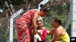 The wife of a prisoner who was killed in a riot cries outside Anisio Jobim Penitentiary Complex in Manaus, Brazil, Jan. 2, 2017. 