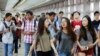 FILE - Students arrive for the first day of school at Stuyvesant High School in New York. A new study says U.S. school districts are failing to ensure that funding is distributed equitably among mostly white and mostly non-white districts.