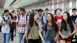 FILE - Students arrive for the first day of school at Stuyvesant High School in New York. A new study says U.S. school districts are failing to ensure that funding is distributed equitably among mostly white and mostly non-white districts.