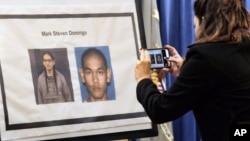A reporter takes a photo of Mark Domingo, 26, from Reseda, California, displayed at a news conference in Los Angeles, April 29, 2019. 