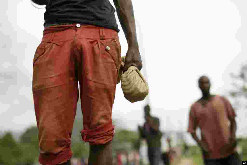 A demonstrator carries a bag of rocks before he faces off against riot police in the Musaga district of Bujumbura, May 4, 2015.