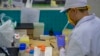 Seorang karyawan bekerja di bagian produksi vaksin Covid-19 di Bio Farma, Bandung, Jawa Barat, 12 Agustus 2020. (Foto: Bayu Ismoyo/ AFP)