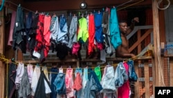 A man in Panama City waits for bags of food being delivered by volunteers of the Panama Solidarity Plan, which offers aid to low-income families during the COVID-19 pandemic on April 1, 2020. 