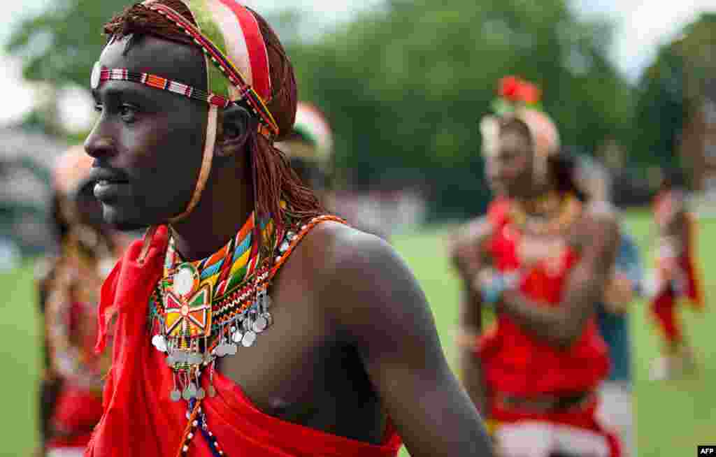 Members of the Maasai Warrior team leave the pitch after a friendly match against the Charity VIII team during opening ceremony activities of the 'Last Man Stands' World Championships at Lords Nursery ground in London, Aug. 25, 2013.