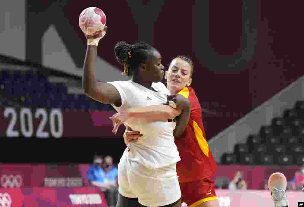Angola's Liliana Venancio, left, challenges for the ball with Montenegro's Jelena Despotovic during the women's preliminary round group A handball match between Montenegro and Angola at the 2020 Summer Olympics, Sunday, July 25, 2021, in Tokyo, Japan. (AP Photo/Sergei Grits)