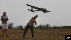 FILE - In this file photo taken Monday, Feb. 15, 2016, a drone is launched in the Hluhluwe-iMfolozi Game Reserve in the KwaZulu Natal province.