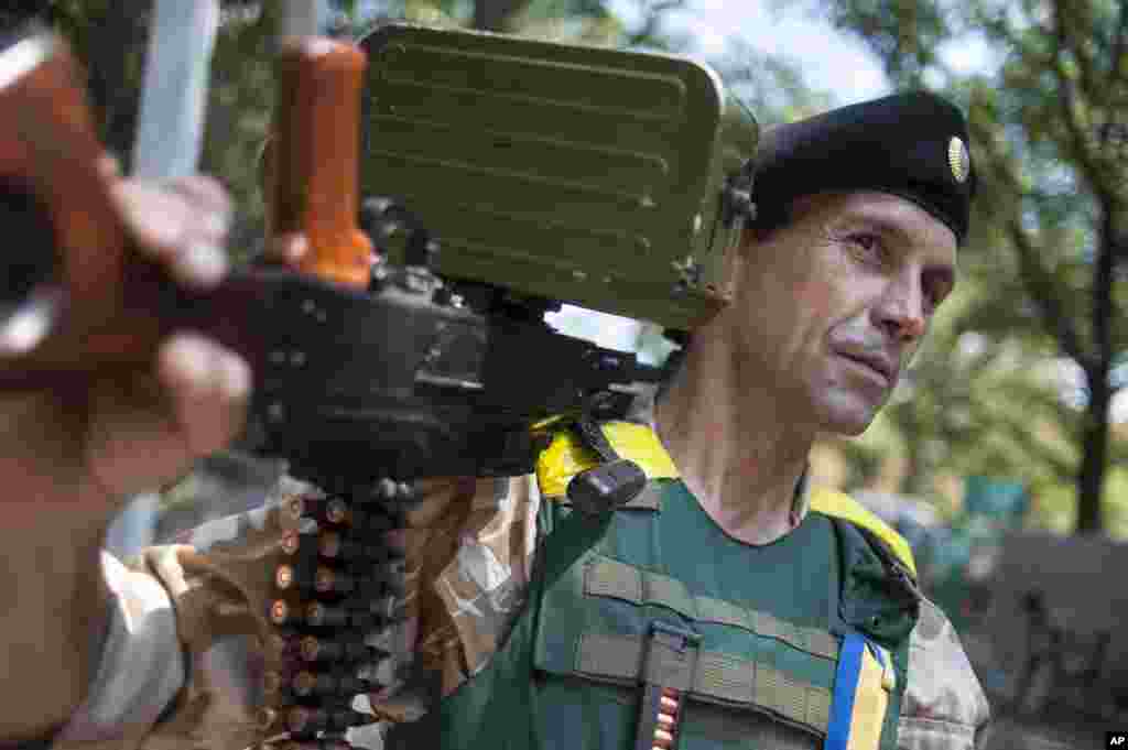 A Ukrainian government soldier from the "Donbass" battalion guards a position in the village of Mariinka, near Donetsk, eastern Ukraine, Aug. 12, 2014.