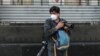 FILE - AFP photographer Alfredo Estrella wears a face mask as he works during the coronavirus pandemic, in Mexico City, Mexico, April 8, 2020. 