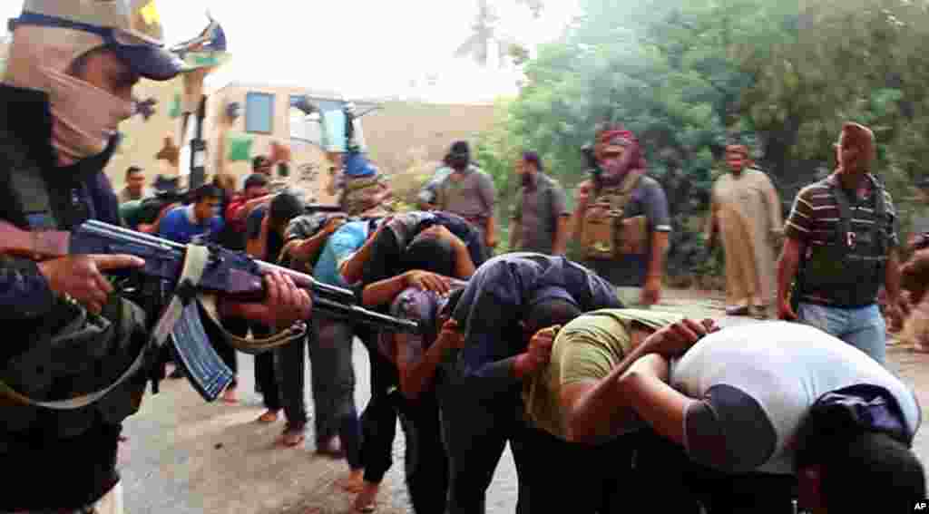 This image posted on a militant website on June 14, 2014 appears to show militants from the Islamic State of Iraq and the Levant moving captured Iraqi soldiers after taking over a base near Tikrit, Iraq.