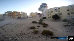 This photo posted on a file sharing website, Jan. 11, 2017, by the Islamic State Group in Sinai, a militant organization, shows an explosion as militants attack an Egyptian police checkpoint on Jan. 9, 2017, in el-Arish, north Sinai, Egypt.