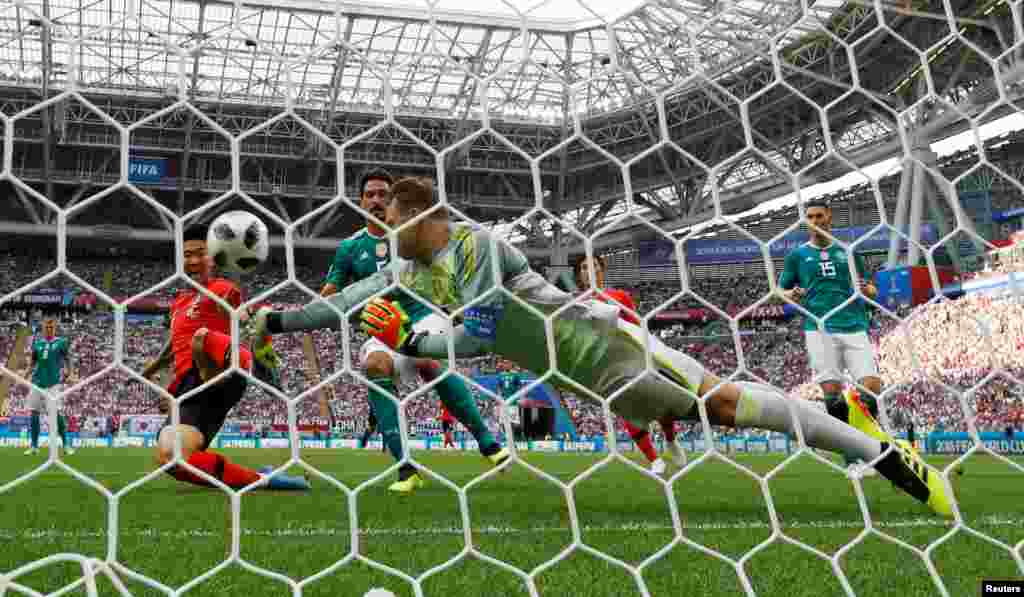 Germany's Manuel Neuer punches the ball away from South Korea's Son Heung-min during the Group F match between South Korea and Germany at the 2018 soccer World Cup in the Kazan Arena in Kazan, Russia.