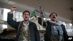 Houthi Shiite fighters chant slogans as they guard a street leading to the residence of former Yemeni President Ali Abdullah Saleh, in Sanaa, Yemen, Dec. 4, 2017. 