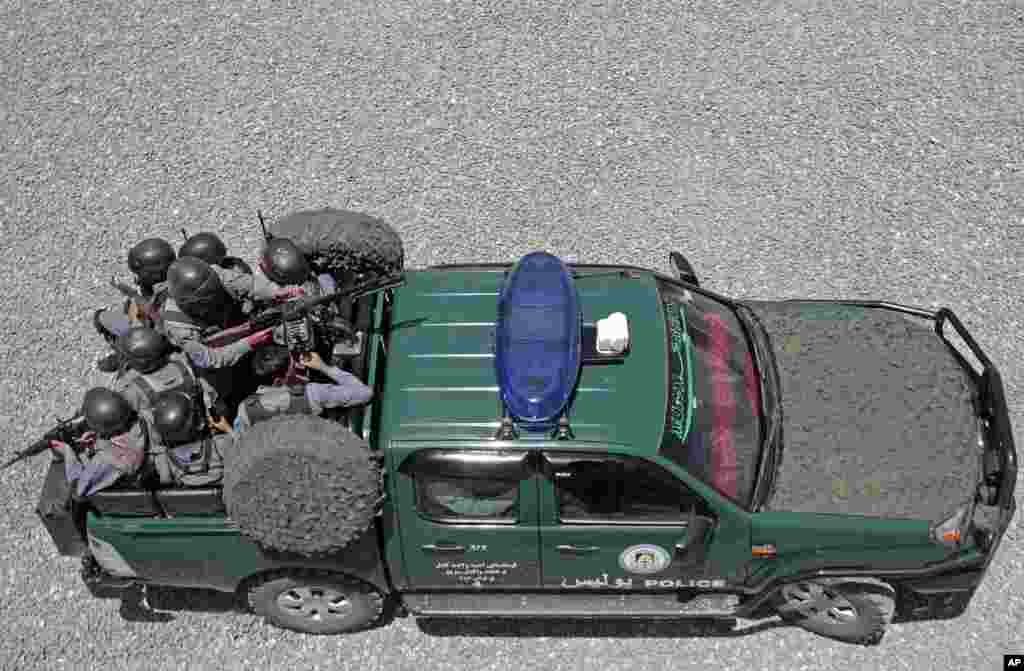 Afghan police and soldiers guard checkpoints at almost every intersection, searching vehicles and frisking drivers in a massive security operation ahead of elections, Kabul, June 13, 2014. 