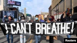 Protesters march through downtown Minneapolis a day before jury selection is scheduled to begin for the trial of Derek Chauvin, the former Minneapolis policeman accused of killing George Floyd, in Minneapolis, Minnesota, March 7, 2021.