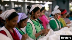 FILE - Women work at Goldtex Limited garment factory inside the Dhaka Export Processing Zone (DEPZ) in Savar, April 11, 2013. 