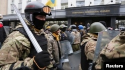 Anti-government demonstrators hold a rally in front of the General Prosecutor Office demanding the release of detained protesters in Kyiv, Ukraine, Feb. 14, 2014.
