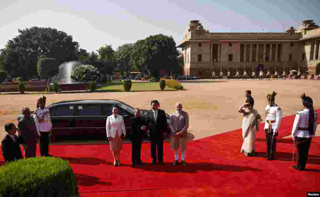 Chinese President Xi Jinping (center, 2nd right) shakes hands with his Indian counterpart Pranab Mukherjee (2nd left) as Xi's wife Peng Liyuan (center left) and India's Prime Minister Narendra Modi (center right) look on during Xi's ceremonial reception at the forecourt of India's Rashtrapati Bhavan presidential palace, New Delhi, Sept. 18, 2014.