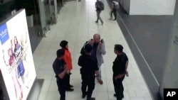 In this image made from airport closed circuit television video and provided by Fuji Television, Kim Jong Nam, exiled half-brother of North Korea's leader Kim Jong Un, gestures towards his face while talking to airport security and officials at Kuala Lumpur, Malaysia, Feb. 13, 2017.
