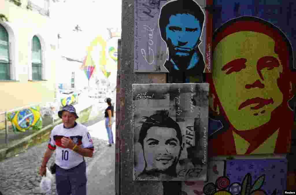 Street art depicts Argentina's Lionel Messi, Portugal's Cristiano Ronaldo and U.S. President Barack Obama, in Salvador, June 15, 2014.