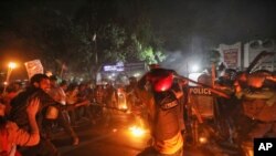 Demonstrators clash with police as they protest the death in prison of a writer who was arrested on charges of violating the sweeping digital security, in Dhaka, Bangladesh, Feb. 26, 2021. 