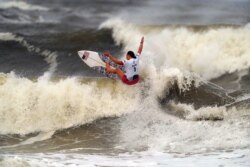 FILE - Carissa Moore competes during the gold medal heat in the women's surfing competition at the 2020 Summer Olympics at Tsurigasaki beach in Ichinomiya, Japan, July 27, 2021. Moore is the only Native Hawaiian surfer at the Games.