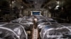 In this image obtained from the U.S. Department of Defense, humanitarian aid pallets rigged with parachutes for an airdrop over Gaza aboard a C-130J Super Hercules are loaded and prepared for takeoff at an undisclosed location in Southwest Asia, March 1, 2024.