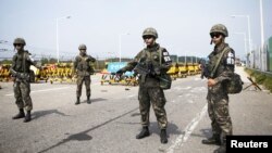 South Korean soldiers stand guard at checkpoint on Grand Unification Bridge which leads to Panmunjom, in Paju, South Korea, Aug. 24, 2015.