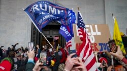 FILE - Protesters loyal to President Donald Trump riot outside the Capitol, Jan. 6, 2021, in Washington.