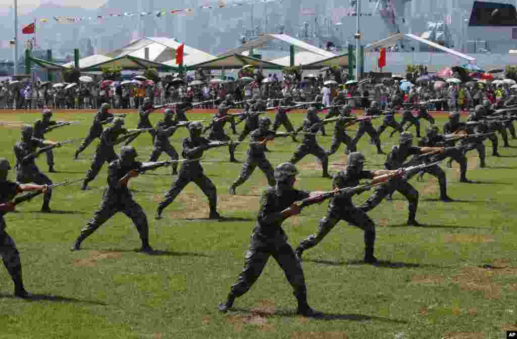 Chinese People's Liberation Army (PLA) personnel demonstrate during the opening day of Stonecutter Island Navy Base. The opening marks the 18th anniversary of the Hong Kong handover to China, in Hong Kong, July 1, 2015.