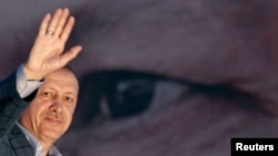 Turkey's Prime Minister Tayyip Erdogan waves to the crowd after he is elected president in a first-round victory, in Istanbul, Turkey, Aug. 10, 2014.