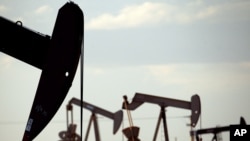 FILE - Pumpjacks are seen in a field near Lovington, New Mexico, April 24, 2015. 