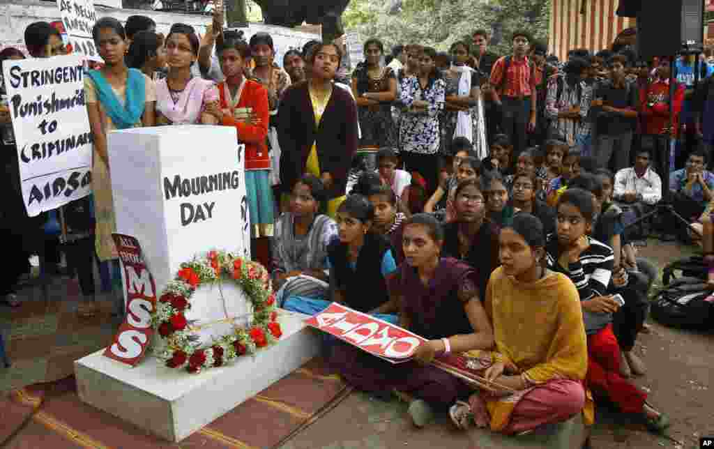 Indians gather next to a makeshift memorial to mourn the death of a 23-year-old gang rape victim, in Bangalore, India , Saturday, Dec. 29, 2012.