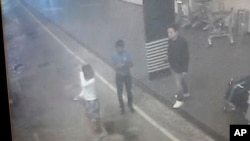 This image provided by Star TV of closed circuit television footage from Feb. 13, 2017, shows a woman, left, at Kuala Lumpur International Airport in Sepang, Malaysia, who police say was arrested Wednesday in connection with the death of Kim Jong Nam.
