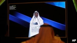 Participants watch Saudi Energy Minister Prince Abdulaziz bin Salman on a screen during his speech at the Future Investment Initiative forum in Riyadh, Saudi Arabia, Oct. 30, 2019.