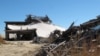 The ruins of an oceanfront home destroyed by Superstorm Sandy is scattered next to an existing home in Mantoloking N.J., Tuesday, Oct. 15, 2013. 