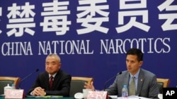 FILE - U.S. Drug Enforcement Administration's representative in Beijing, Lance Ho, right, speaks next to Wei Xiaojun, deputy director-general of the Narcotics Control Bureau of the Ministry of Public Security during a press conference in Beijing, earlier in November 2017. (AP Photo/Andy Wong) 