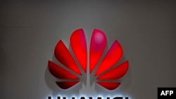FILE - The Huawei logo is seen at a Huawei store at a shopping mall in Beijing, July 4, 2018. The Chinese-owned telecommunications giant has been blocked from rolling out Australia's 5G network because of security concerns.