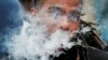 FILE - A demonstrator vapes during a protest at the Massachusetts State House against the state's four-month ban of all vaping product sales in Boston, Massachusetts, Oct. 3, 2019.