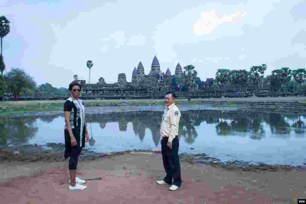 Michelle Obama walks with her tour guide in Angkor Wat compound, March 21, 2015.