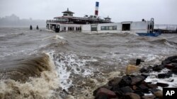 An historic ferry boat named the Binghamton is swamped by the waves on the Hudson River in Edgewater, N.J., Monday, Oct. 29, 2012 as Hurricane Sandy lashed the East Coast.