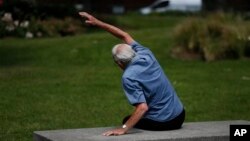 In this Tuesday, June 17, 2014 photo, George Jackson, 85, an army veteran and former boxer participates at a parkour class for elderly people at a park in south London. 'I just sometimes forget how old I am and that I can’t do certain things', said Jackson, the class’ oldest participant. The unique weekly class for people over 60 called parkour, a flashy discipline usually known for its acrobatic running, climbing and gravity-defying jumps. He said he struggles with a swollen ankle and knee but that the class has helped. 'I was limping around before and now I can walk straight,' Jackson said. 'But I still don’t plan to jump off of anything higher than a bench'.(AP Photo/Lefteris Pitarakis)