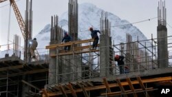In preparation for the 2014 Winter Games at the Black Sea resort of Sochi, a hotel is under construction in nearby Krasnaya Polyana, Russia, Feb. 4, 2013.