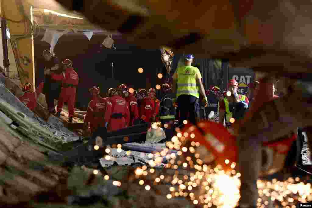Rescuers work at the scene where the roof of a train station collapsed, killing several people, in Novi Sad, Serbia.