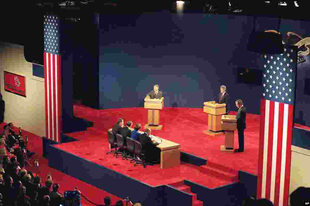 Presidential candidates, from left, Ross Perot, Bill Clinton, and President George Bush, participate in the first presidential debate in St. Louis, Missuori, Oct. 12, 1992.