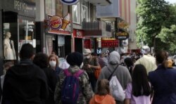 FILE - People walk along popular Tunali Hilmi Street, in Ankara, Turkey, June 3, 2020, days after the government lifted a series of restrictions imposed to fight the coronavirus pandemic.