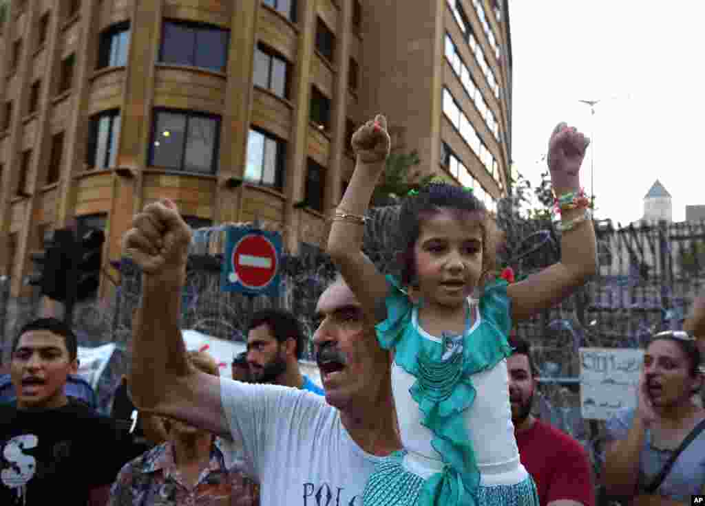 Lebanese anti-government protesters demonstrate against the ongoing trash crisis and government corruption near the government building, in downtown Beirut, Sept. 2, 2015. 