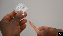A Covid-19 AstraZenaca vaccine is prepared at the NHS Nightingale facility at the Excel Centre, London, Jan. 11, 2021.